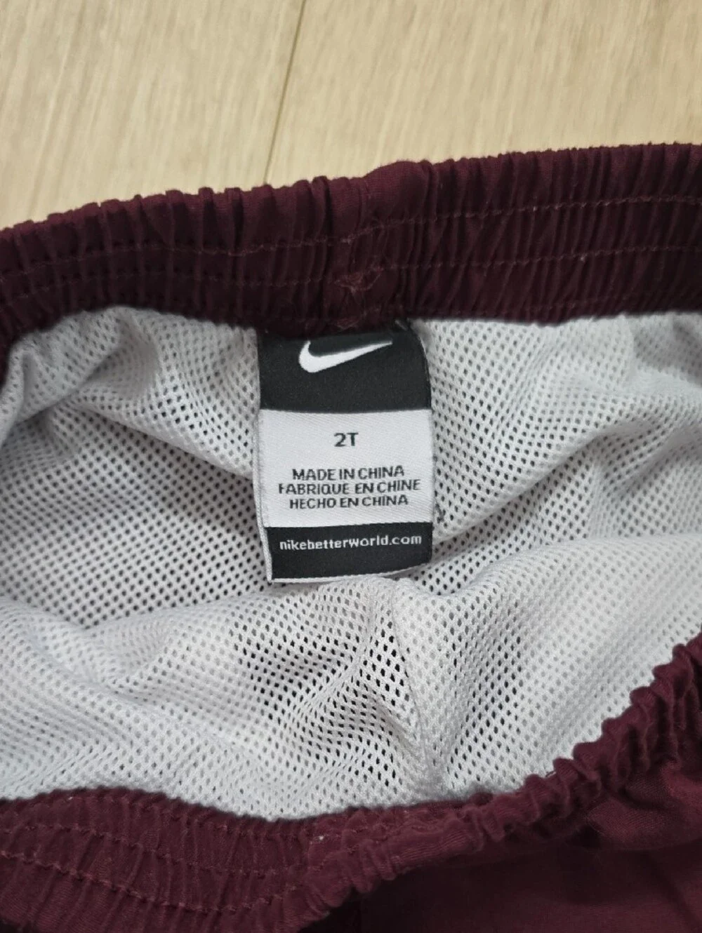 Nike Kids Burgundy Pants with Orange Side Stripes